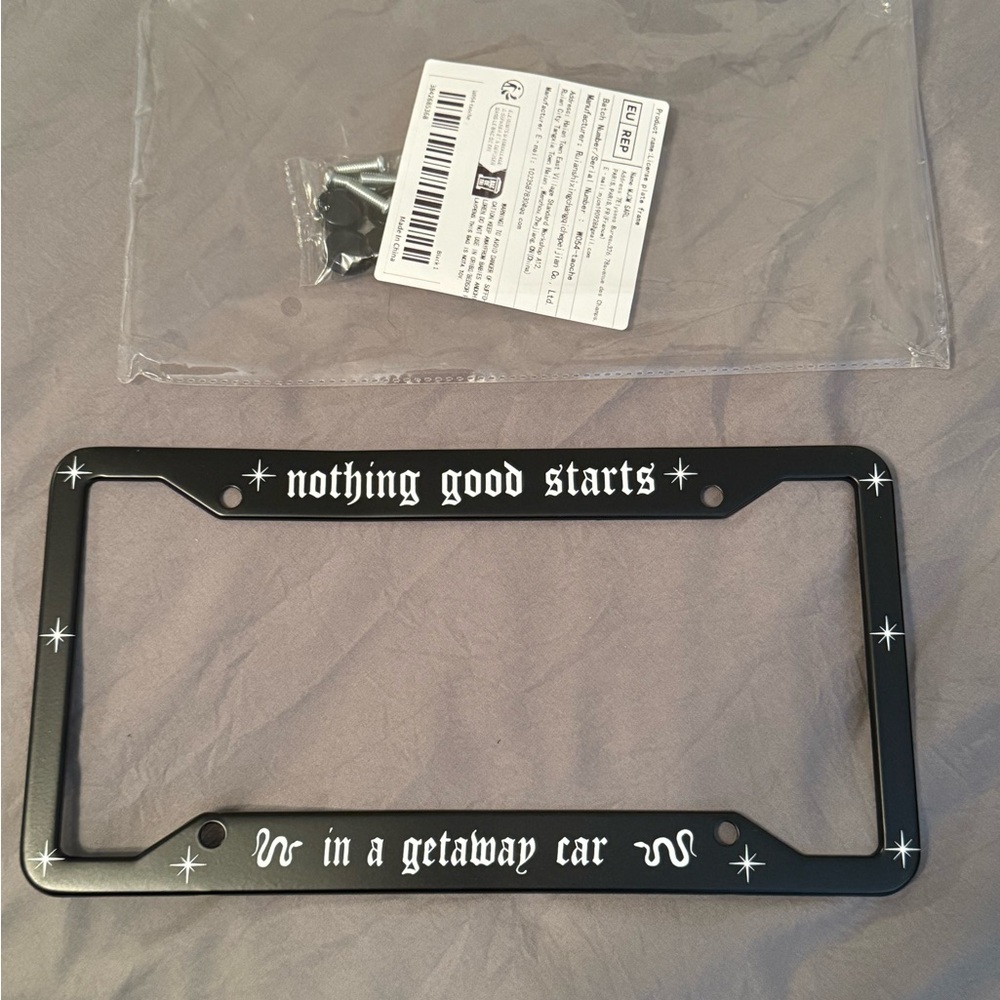 Black License Plate Frame with White Text